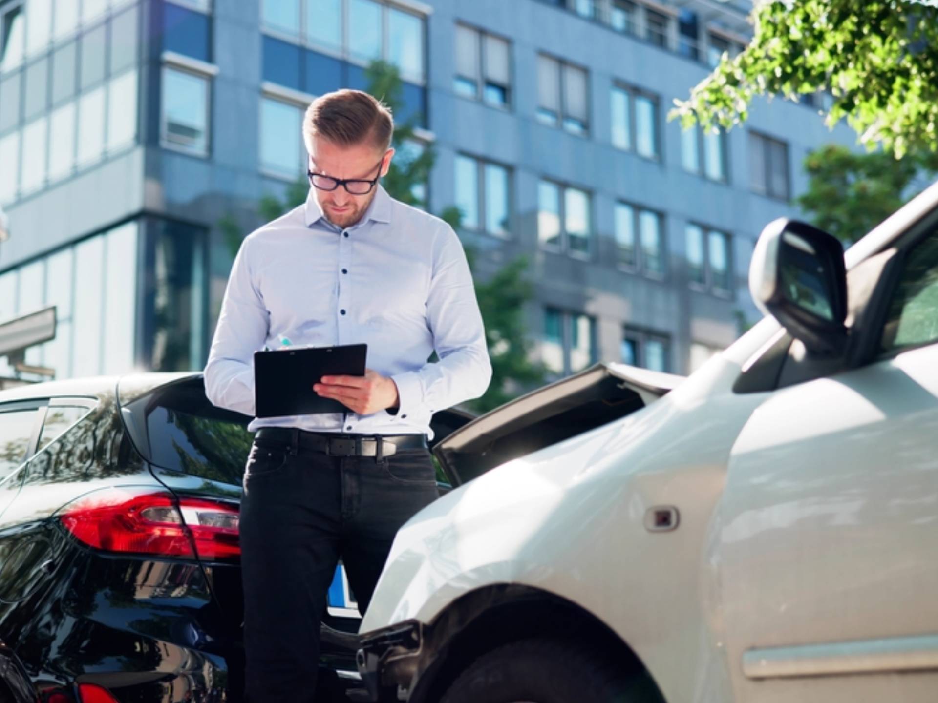 Insurance Agent Assessing Car Damage After Accident Claim For Client's Auto
